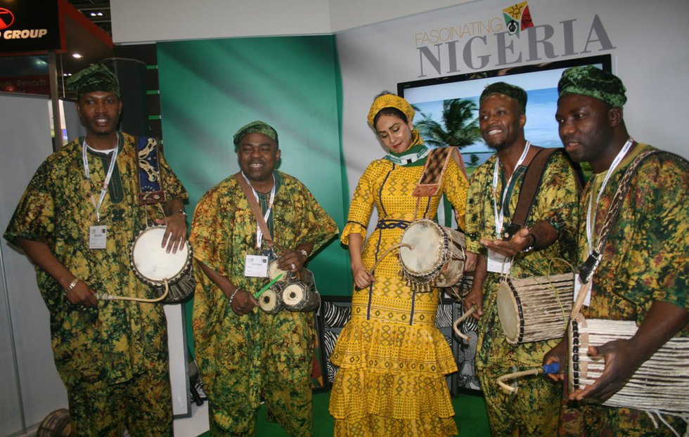 Mrs. Sally Mbanefo with the Oduduwa  Talking Drummers - Ayan De First in Europe entertaining guests at the stand.