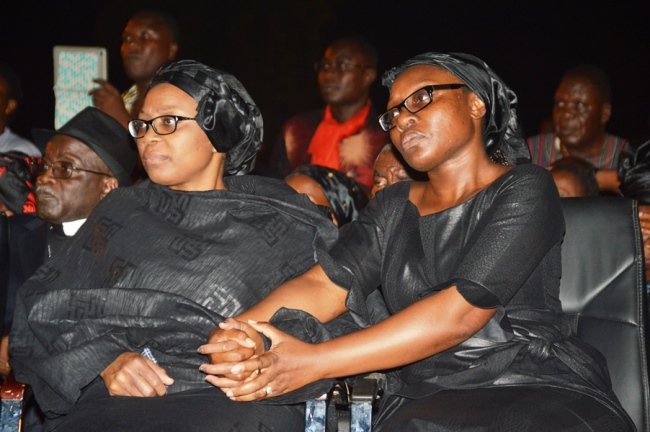 Komla's wife Kwamsema (left) and sister Mawuena (right) holding hands during the ceremony