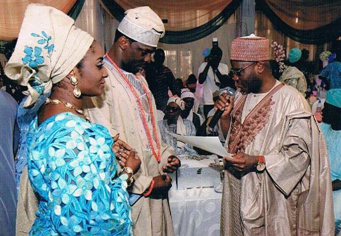 Nigeria's Former Chief Justice of the Federation - Alfa Modibbo Belgore handing over the marriage certificate to the couple
