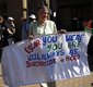 A woman holds a banner in support of Pistorius