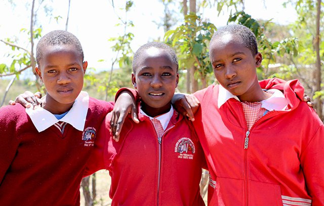 Faith (centre) with her friends Sylvia (right) and Vivian, who all ran away from home to avoid female genital mutilation and child marriage.