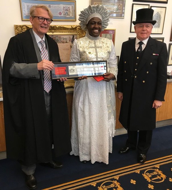 Rev Esther Ajayi flanked by Clerk of the Chamberlain&#x27;s Court and the Beadle