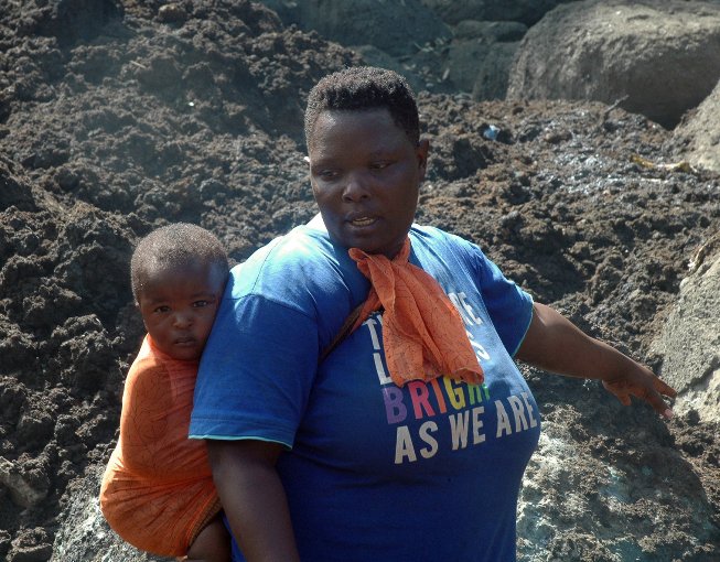 Esther Nambuba showing off where her resturant and bar covered with boulders