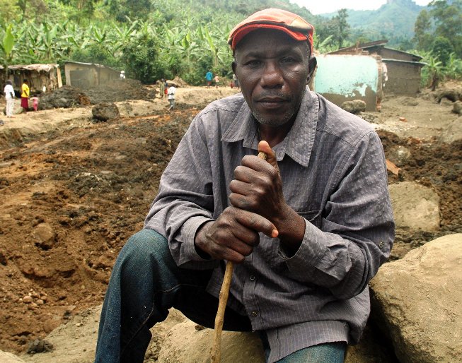 Lawrance Khisa seated in the boulders at Wangemen trading centre which was completely destroyed