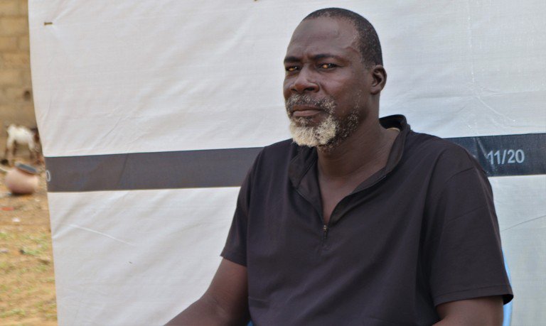Sambo, a displaced man from Seytenga, sitting before his tent