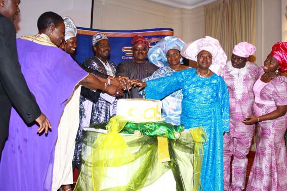 Cutting the celebratory cake, Mayor of Enfield Cllr. Kate Anolue, Mr & Mrs Femi Okutubo, Ambassador & Mrs Lawal, Ms. Alison Shoyombo and Pastor & Mrs Gbenga Okutubo.JPG